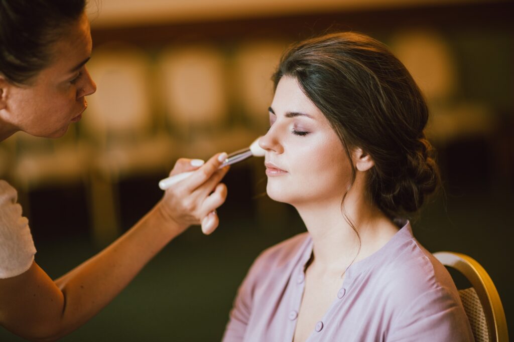 Makeup artist works with young woman