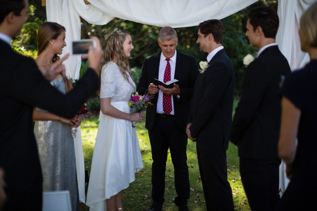 Minister giving speech to bride and groom