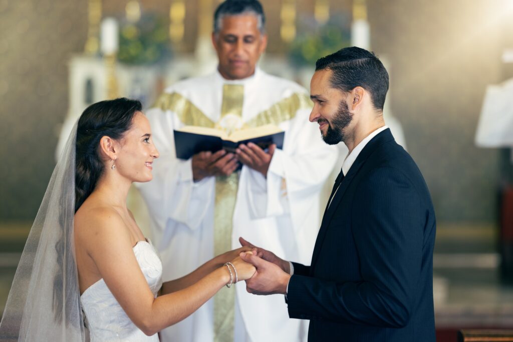 Couple getting married, wedding vows and love commitment at the alter of church during marriage cer