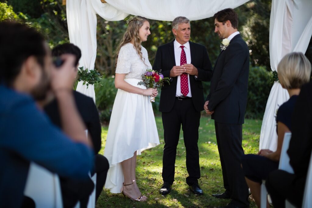 Minister giving speech to bride and groom