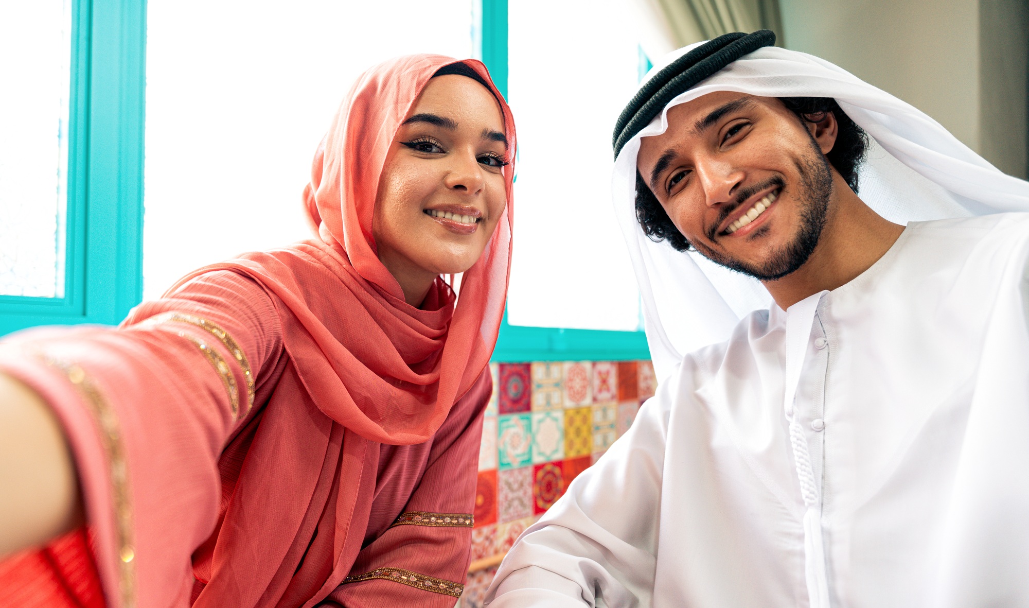 Young couple from Emirati spending time in a cafe